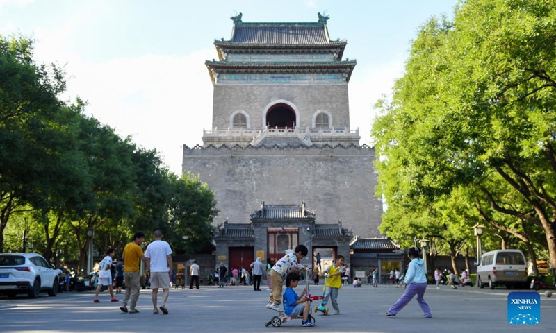Children have fun at a square between the Drum Tower and the Bell Tower in Beijing, capital of China, June 9, 2023. First created in the Yuan Dynasty (1271-1368), the Beijing Central Axis, or Zhongzhouxian, stretches 7.8 kilometers between the Yongding Gate (Yongdingmen) in the south of the city and the Drum Tower and Bell Tower in the north.(Photo: Xinhua)