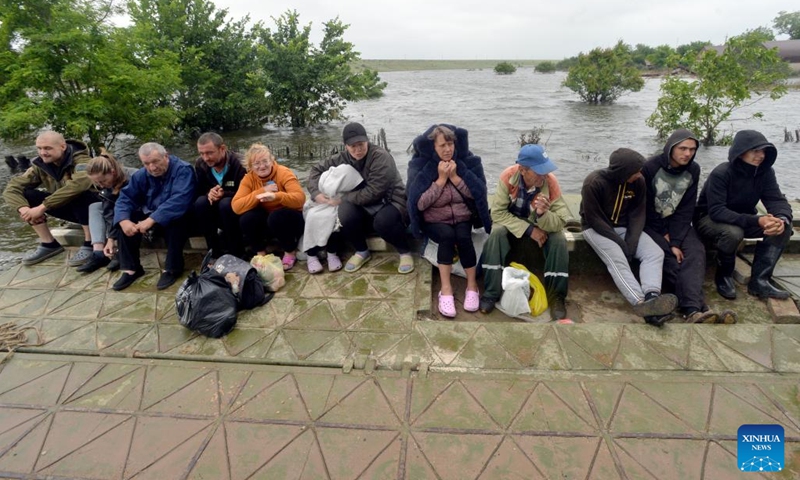 People are pictured in Afanasiyivka, Mykolaiv region, June 12, 2023. The Kakhovka hydroelectric power plant was destroyed on June 6, causing a decrease of the dam water level and massive flooding in nearby areas.(Photo: Xinhua)