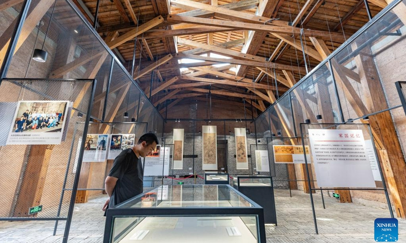 A tourist visits a museum displaying the history of Palace Museum antiques moved there during World War II in southwest China's Chongqing, June 10, 2023. The museum is located in a former foreign firm, where nearly 4,000 cases of antiques were stored during wartime. The items from the Palace Museum, also known as the Forbidden City, were moved to Chongqing in late 1930s when Japanese troops invaded Beijing.(Photo: Xinhua)