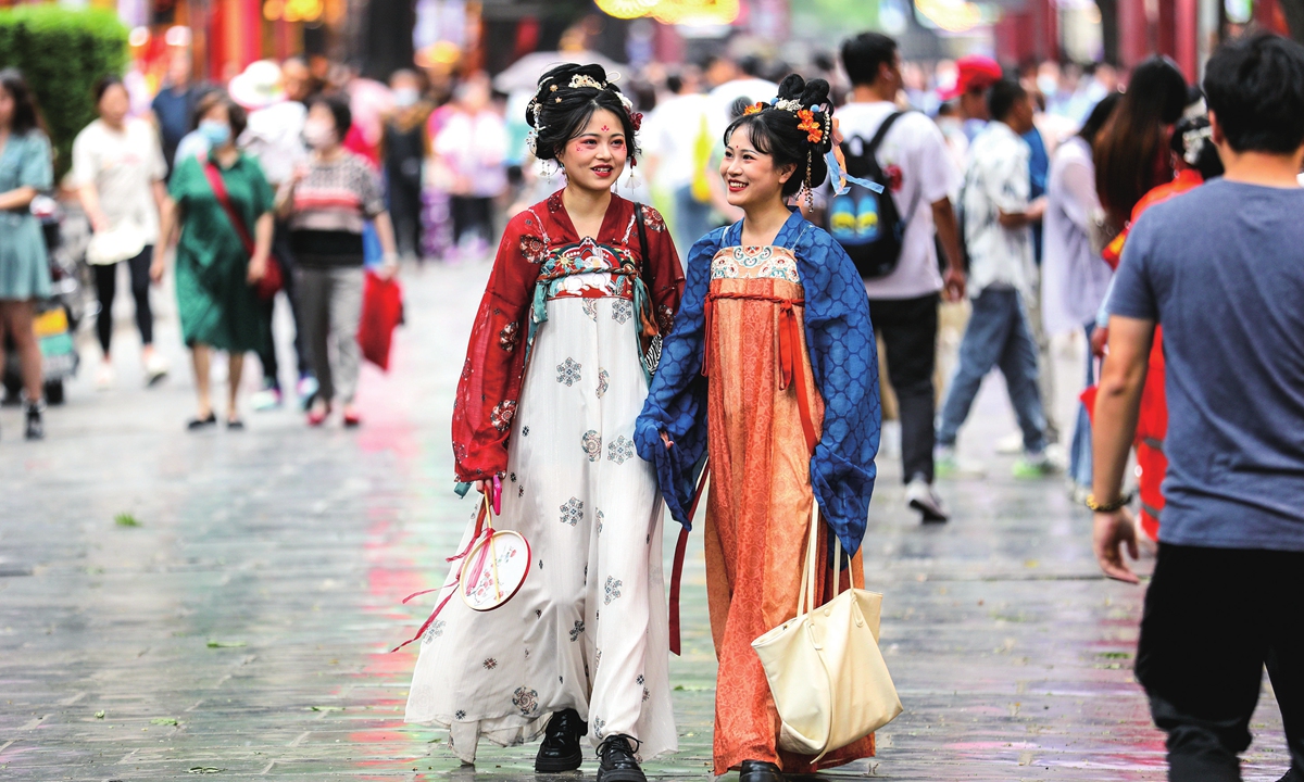 Two girls in traditional Chinese clothes walk on the street in scenic spot Great Tang All Day Mall in Xi'an. 
Photo: IC 
