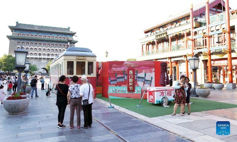 People visit Qianmen Street in central Beijing, capital of China, June 6, 2023. First created in the Yuan Dynasty (1271-1368), the Beijing Central Axis, or Zhongzhouxian, stretches 7.8 kilometers between the Yongding Gate (Yongdingmen) in the south of the city and the Drum Tower and Bell Tower in the north. Most of the major old-city buildings of Beijing sit along this axis. (Photo: Xinhua)