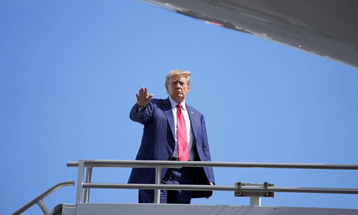 Former US President Donald Trump waves before boarding his personal plane at Miami International Airport, June 13, 2023, in Miami. Trump appeared in federal court Tuesday on dozens of felony charges accusing him of illegally hoarding classified documents and thwarting the Justice Department's efforts to get the records back. Photo: VCG