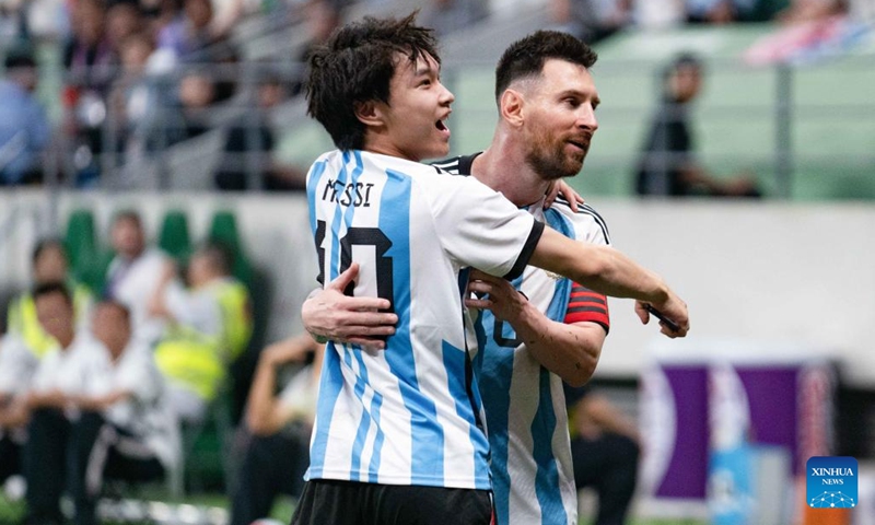 A pitch-invading fan (L) hugs Lionel Messi of Argentina during an international football invitational between Argentina and Australia in Beijing, capital of China, June 15, 2023.(Photo: Xinhua)