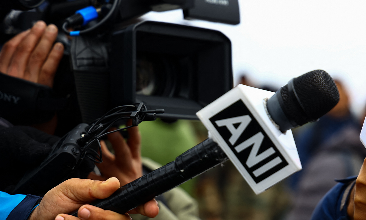 A reporter holds a microphone with the logo of ANI during a press conference in India, on March 3, 2023. Photo: VCG