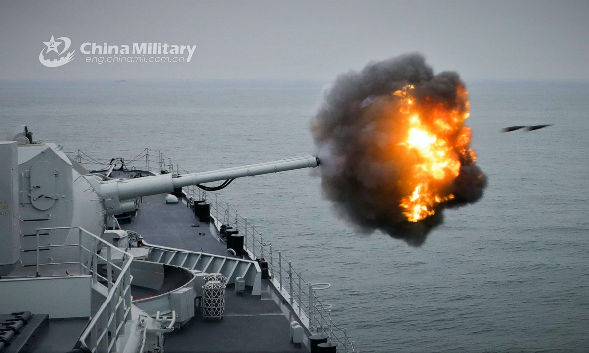 A destroyer attached to a naval destroyer flotilla under the PLA Eastern Theater Command fires its main gun at mock target during a recent live force-on-force training exercise. (eng.chinamil.com.cn/Photo by Wen Zidong)