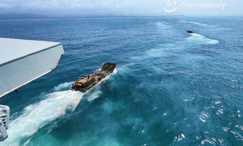 A group of amphibious armored vehicles attached to a brigade of the PLA 74th Group Army maneuver towards designated target area in formation to make their ways to the beach-head during a recent amphibious assault training exercise. (eng.chinamil.com.cn/Photo by Li Bin)
