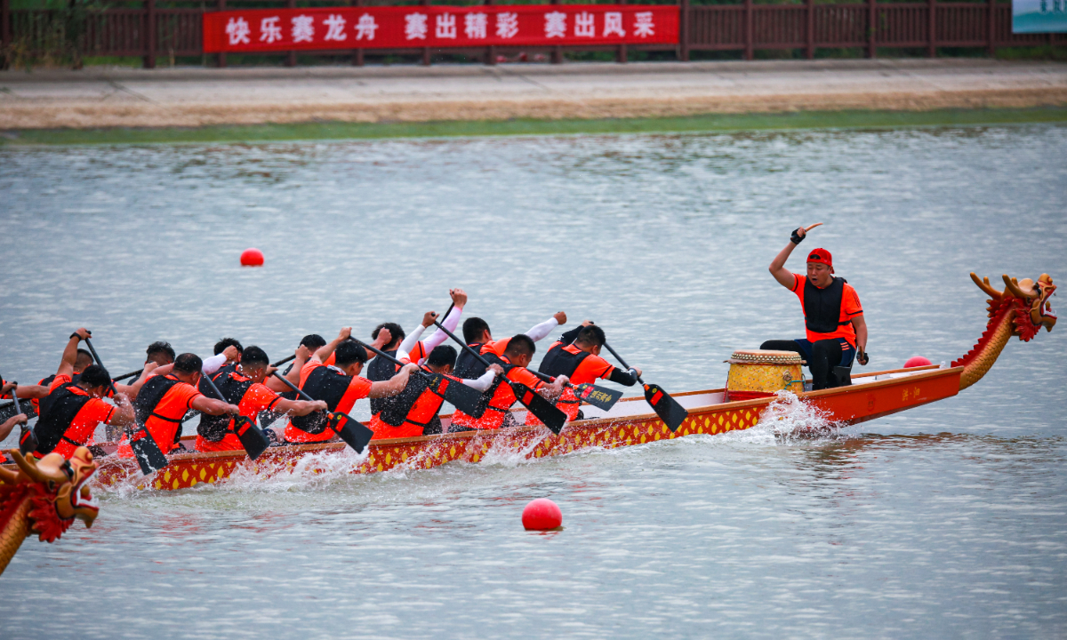 People compete in a dragon boat race. Photo: VCG