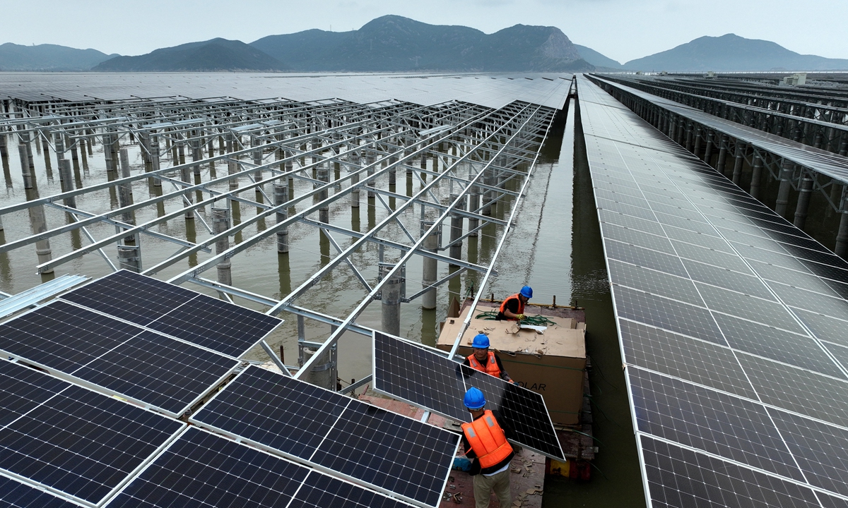 Workers install photovoltaic (PV) power generation panels in Daishan, East China's Zhejiang Province on June 20, 2023. China's PV industry registered strong expansion during the March-April period, as the output growth of polysilicon, silicon wafers, batteries, and components all exceeded 72 percent year on year, official data showed. Photo: cnsphoto