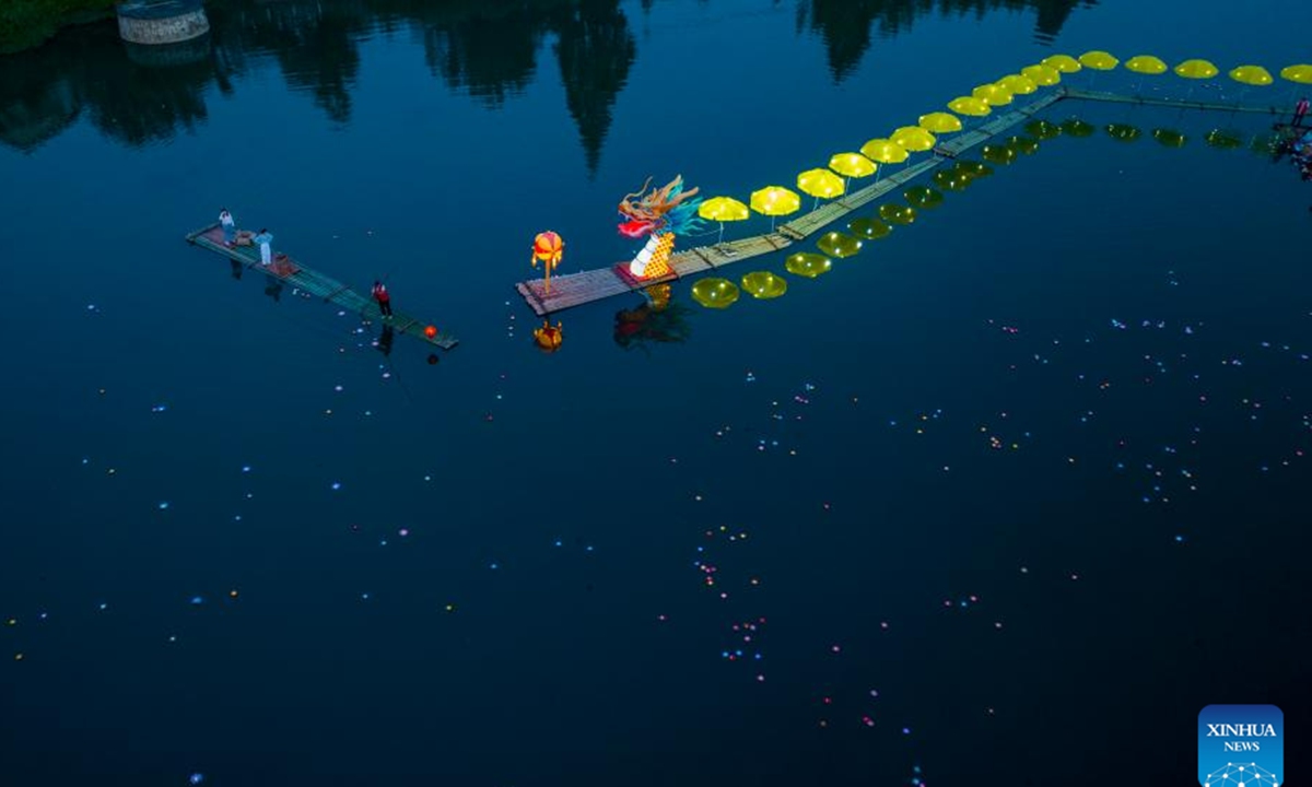This aerial photo taken on June 16, 2023 shows a lantern performance in Hule Town of Ningguo City, east China's Anhui Province. Hule Town, an ancient town in east China's Anhui Province, has a tradition of lantern performance to celebrate festivals.