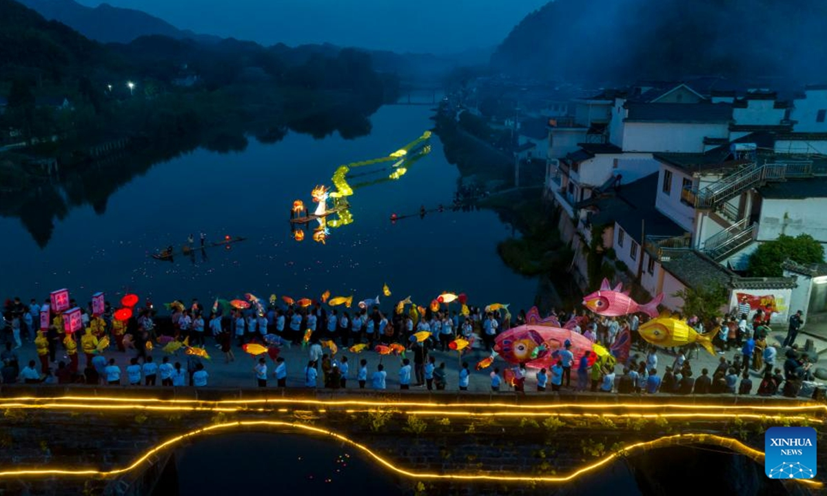 This aerial photo taken on June 16, 2023 shows a lantern performance in Hule Town of Ningguo City, east China's Anhui Province. Hule Town, an ancient town in east China's Anhui Province, has a tradition of lantern performance to celebrate festivals.