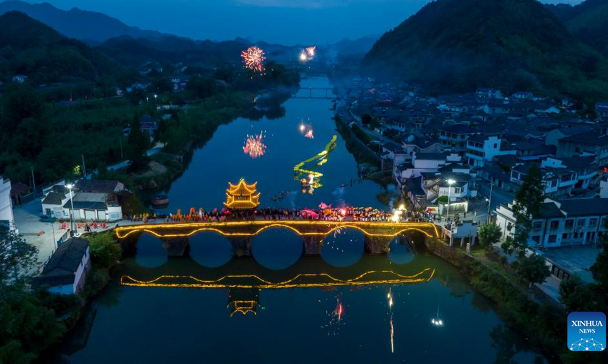 This aerial photo taken on June 16, 2023 shows a lantern performance in Hule Town of Ningguo City, east China's Anhui Province. Hule Town, an ancient town in east China's Anhui Province, has a tradition of lantern performance to celebrate festivals.