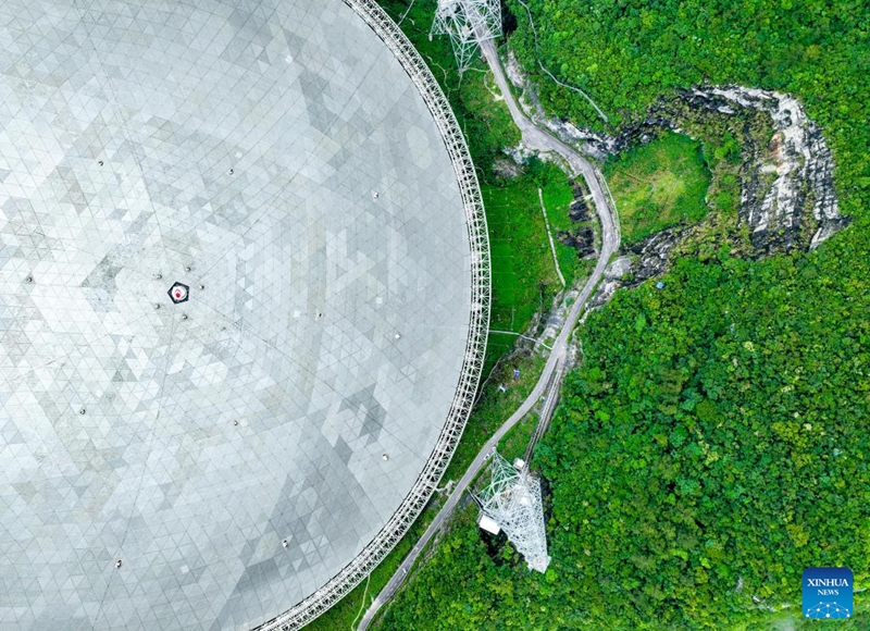 This aerial photo taken on June 22, 2023 shows China's Five-hundred-meter Aperture Spherical Radio Telescope (FAST) under maintenance in southwest China's Guizhou Province. China's FAST telescope identified a binary pulsar with an orbital period of 53.3 minutes, the shortest known period for a pulsar binary system.The research, mainly conducted by a team led by scientists from the National Astronomical Observatories of the Chinese Academy of Sciences (NAOC), was published in the journal Nature Wednesday. (Xinhua/Ou Dongqu)