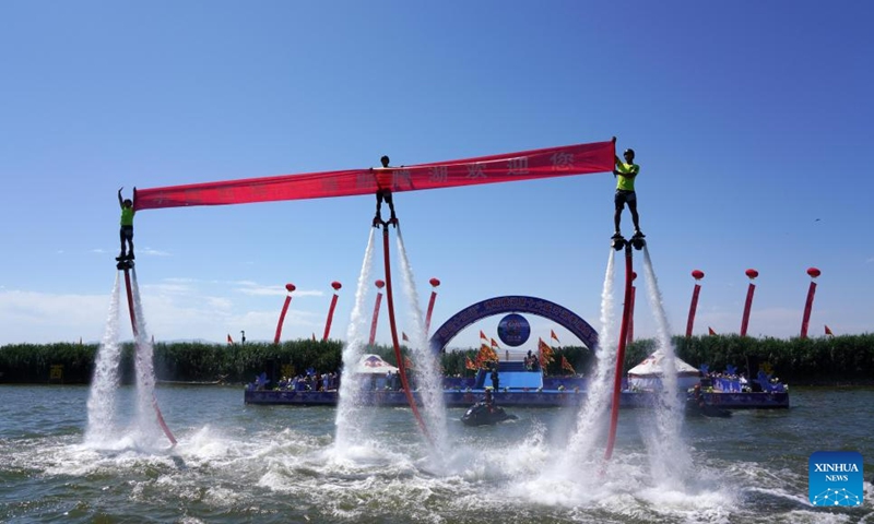 A water stunt show is staged during the 16th Fishing Festival in the Open Season of Bosten Lake in Bohu County, northwest China's Xinjiang Uygur Autonomous Region, June 23, 2023. Photo: Xinhua