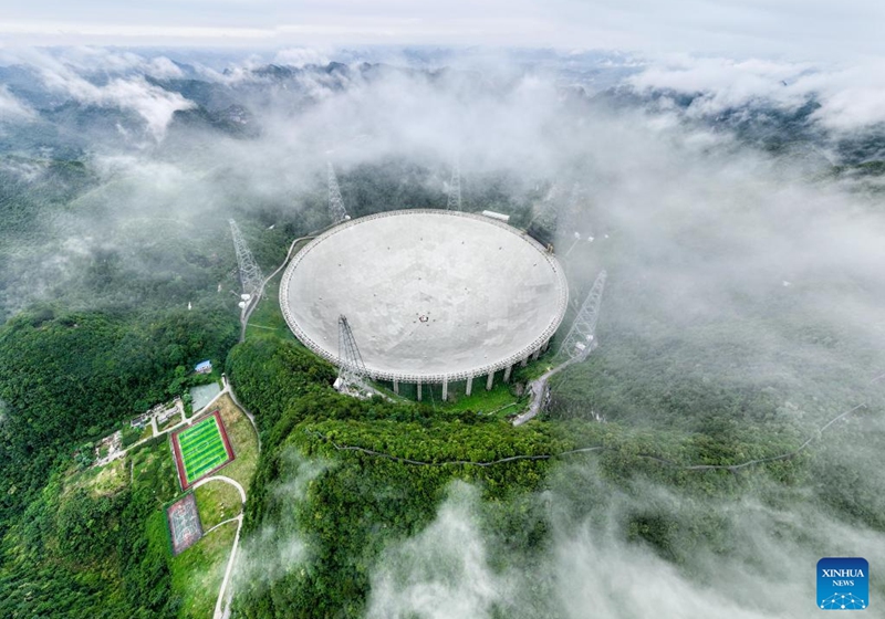 This aerial photo taken on June 22, 2023 shows China's Five-hundred-meter Aperture Spherical Radio Telescope (FAST) under maintenance in southwest China's Guizhou Province. China's FAST telescope identified a binary pulsar with an orbital period of 53.3 minutes, the shortest known period for a pulsar binary system.The research, mainly conducted by a team led by scientists from the National Astronomical Observatories of the Chinese Academy of Sciences (NAOC), was published in the journal Nature Wednesday. (Xinhua/Ou Dongqu)