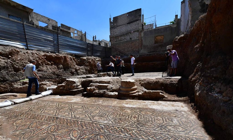 People work at the site of a Roman-era mosaic panel recently uncovered in the city of al-Rastan in Homs, Syria, on June 22, 2023. (Photo by Ammar Safarjalani/Xinhua)