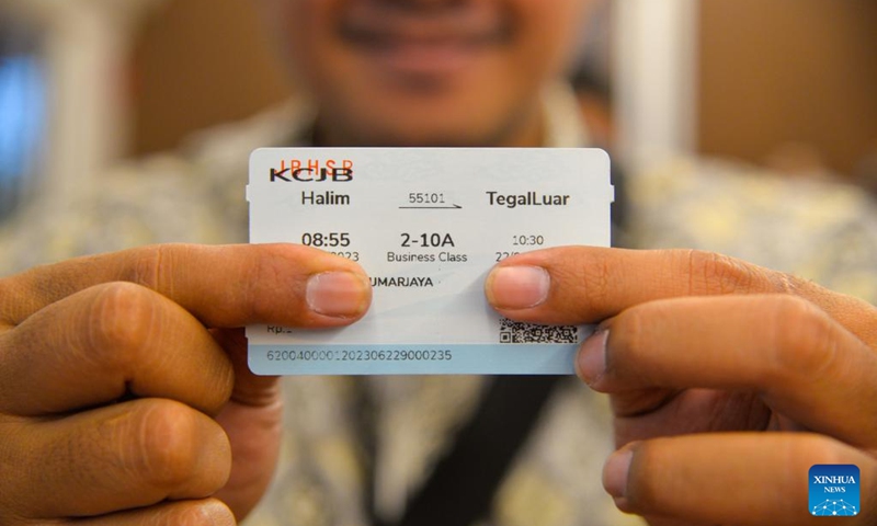A journalist shows a Jakarta-Bandung High-Speed Railway commemorative sample ticket on a comprehensive inspection train during the joint commissioning and testing phase for the Jakarta-Bandung High-Speed Railway in Indonesia, June 22, 2023. The comprehensive inspection train (CIT) of Jakarta-Bandung High-Speed Railway (HSR) reached 350 km per hour, the design speed, for the first time on Thursday during the joint commissioning and testing phase. (Xinhua/Xu Qin) 