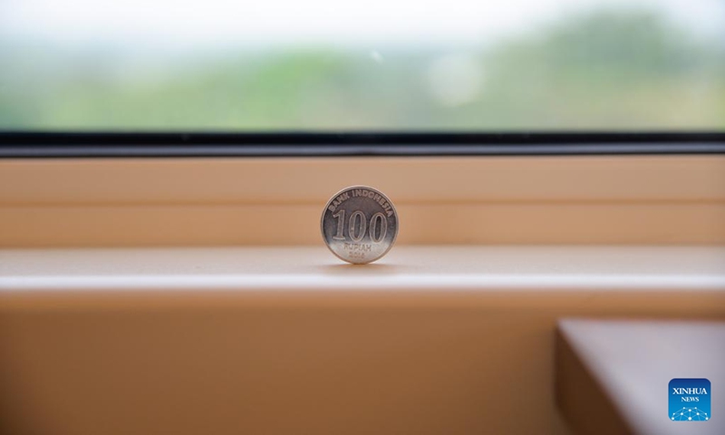 An Indonesian coin stands firmly on the windowsill of a comprehensive inspection train during the joint commissioning and testing phase for the Jakarta-Bandung High-Speed Railway in Indonesia, June 22, 2023. The comprehensive inspection train (CIT) of Jakarta-Bandung High-Speed Railway (HSR) reached 350 km per hour, the design speed, for the first time on Thursday during the joint commissioning and testing phase. (Xinhua/Xu Qin)