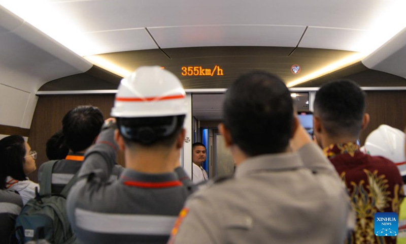 Journalists and staff members take photos and videos of a train screen which shows the train speed exceeding 350 kilometers per hour on a comprehensive inspection train during the joint commissioning and testing phase for the Jakarta-Bandung High-Speed Railway in Indonesia, June 22, 2023. The comprehensive inspection train (CIT) of Jakarta-Bandung High-Speed Railway (HSR) reached 350 km per hour, the design speed, for the first time on Thursday during the joint commissioning and testing phase.(Xinhua/Xu Qin)