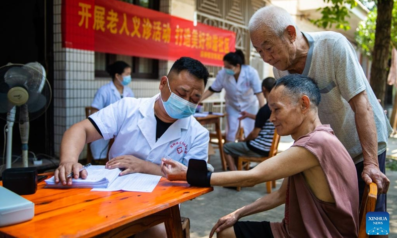 A medical worker conducts medical examination for a senior resident at a nursing home in Anxiang County of Changde City, central China's Hunan Province, June 21, 2023. The city of Changde has scaled up efforts to develop an elderly care service system composed mainly of in-home cares, community services, institutional and medical cares. (Xinhua/Chen Sihan)