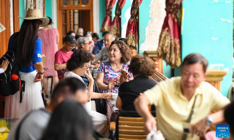 People spend their leisure time at a teahouse in the ancient city of Kashgar scenic area in Kashgar, northwest China's Xinjiang Uygur Autonomous Region, June 13, 2023. (Xinhua/Hu Huhu)