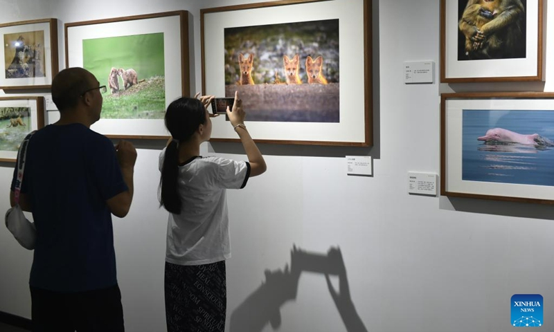 Visitors view photos at a photography exhibition during the 14th China Photography Festival in Sanmenxia City of central China's Henan Province, June 22, 2023. (Xinhua/Lu Peng)