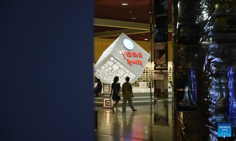 Visitors view photos at a photography exhibition during the 14th China Photography Festival in Sanmenxia City of central China's Henan Province, June 22, 2023. (Xinhua/Lu Peng)