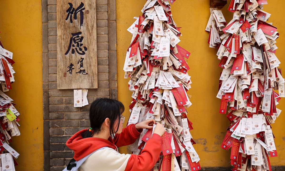 A female student prays for blessings at a temple in Xi 'an, Northwest China's Shaanxi Province, on June 5, 2023. Photo: IC