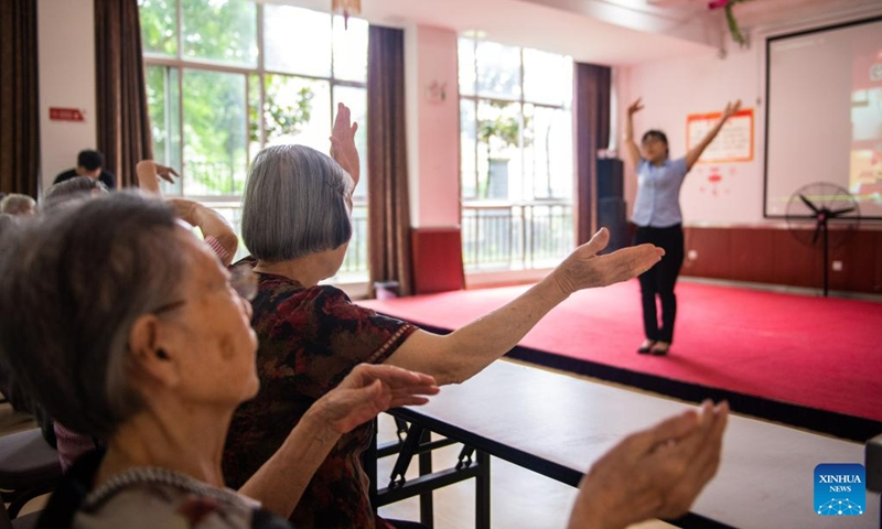 Senior residents dance following the guidance of a staff member at a social welfare center in Hanshou County of Changde City, central China's Hunan Province, June 20, 2023. The city of Changde has scaled up efforts to develop an elderly care service system composed mainly of in-home cares, community services, institutional and medical cares. (Xinhua/Chen Sihan)