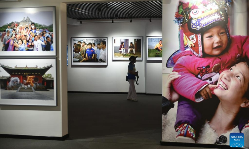 A visitor views photos at a photography exhibition during the 14th China Photography Festival in Sanmenxia City of central China's Henan Province, June 22, 2023. (Xinhua/Lu Peng)