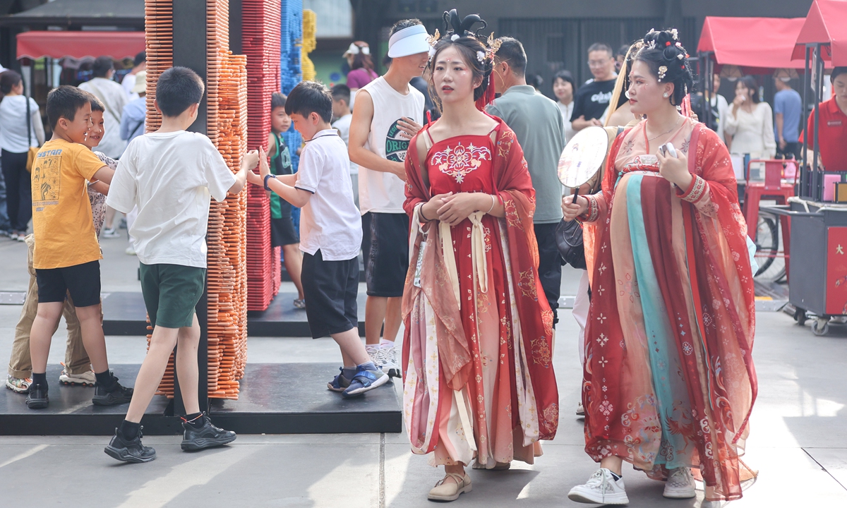 Visitors wearing Han clothing walk in the Datang Everbright City scenic area in Xi'an, Northwest China's Shaanxi Province, on June 24, 2023, the last day of the Dragon Boat Festival, also known as Duanwu Festival. Photo: IC 