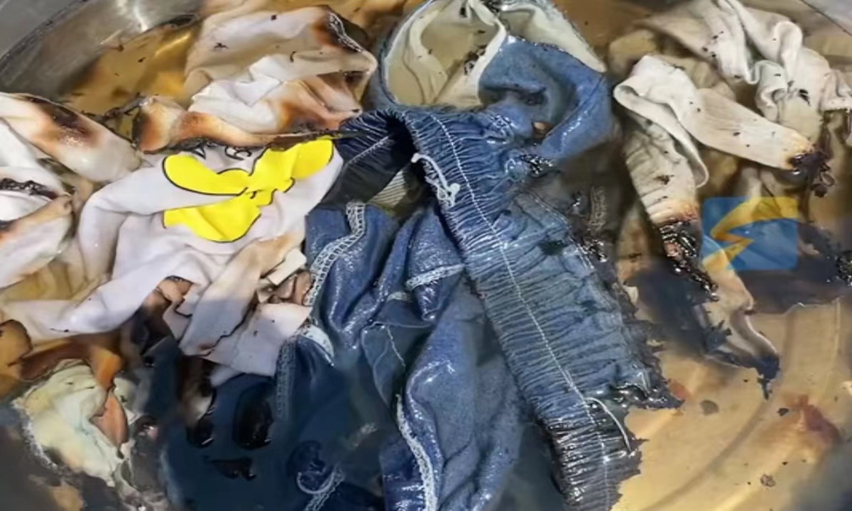 A woman from Langfang, North China's Hebei Province, shared a video on social media showing clothes placed in a
stainless steel basin being heated to the point of emitting smoke, providing a vivid demonstration of the power of the scorching 41-degree heat. Photo: Shandian News