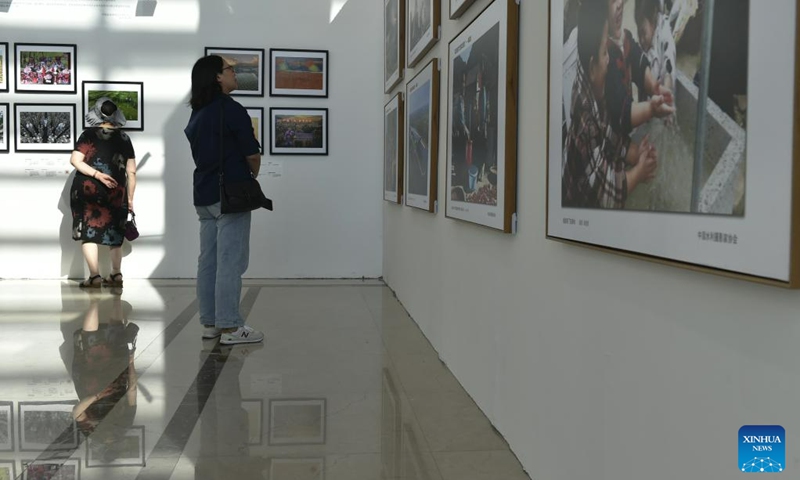 Visitors view photos at a photography exhibition during the 14th China Photography Festival in Sanmenxia City of central China's Henan Province, June 22, 2023. (Xinhua/Lu Peng)