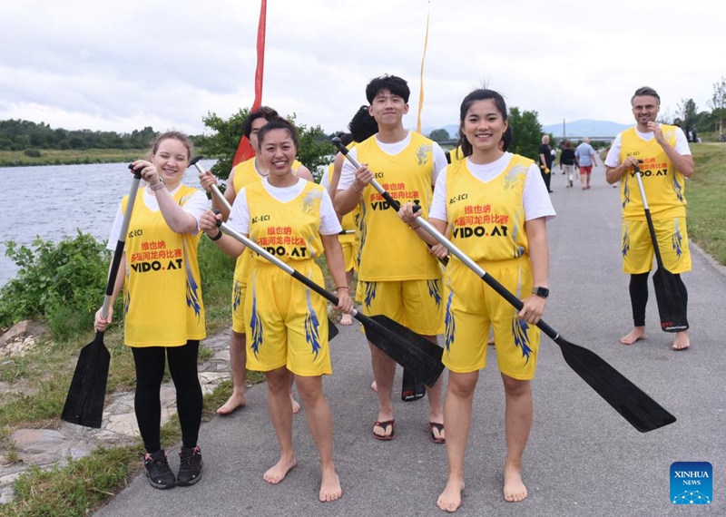 Members of Team CRRC Dragon Express pose for photos before the 2023 Vienna Danube Dragon Boat Cup in Vienna, Austria, June. 24, 2023. (Xinhua/He Canling)