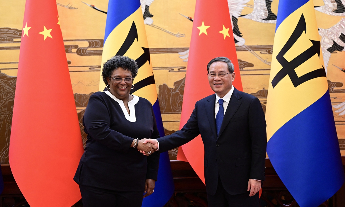 Chinese Premier Li Qiang (right) and Barbados Prime Minister Mia Mottley shake hands at the Great Hall of the People in Beijing on June 25, 2023. Photo:AFP