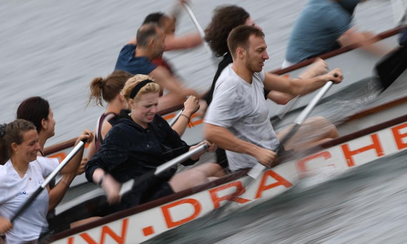 Members of dragon boat teams compete during the 2023 Vienna Danube Dragon Boat Cup in Vienna, Austria, June. 24, 2023. (Xinhua/He Canling)