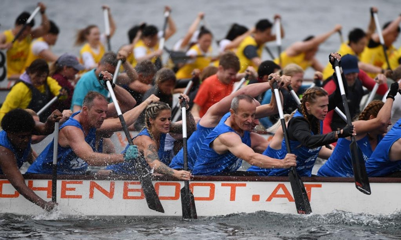 Members of Team Allianz Blue Warriors compete during the 2023 Vienna Danube Dragon Boat Cup in Vienna, Austria, June. 24, 2023. (Xinhua/He Canling)