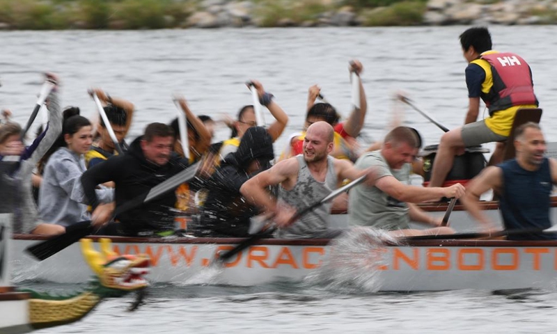 Members of dragon boat teams compete during the 2023 Vienna Danube Dragon Boat Cup in Vienna, Austria, June. 24, 2023. (Xinhua/He Canling)