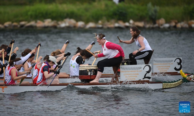 Members of Team Vienna Pink Dragons & Friends compete during the 2023 Vienna Danube Dragon Boat Cup in Vienna, Austria, June. 24, 2023. (Xinhua/He Canling)