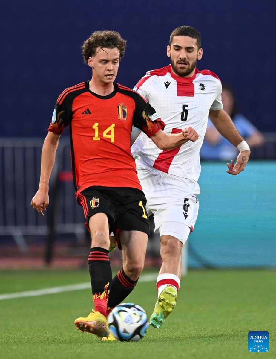 Saba Khvadagiani (R) of Georgia vies with Maxim De Cuyper of Belgium during their group A match of the UEFA U21 Championship in Tbilisi, Georgia, on June 24, 2023. (Photo by Tamuna Kulumbegashvili/Xinhua)