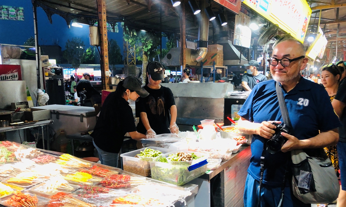 Mr Sonoyama, a member of the Japanese tour group, visits a night market in Aksu of Xinjiang region. Photo: Courtesy of Guo Qiang 