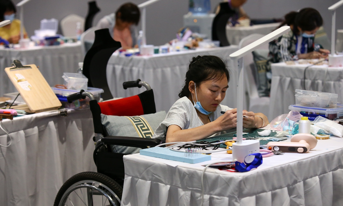 Contestants work on apparel design during the 7th National Skills Competition for the Disabled on June 27, 2023, in Jinan, East China's Shandong Province. The event is organized every four years and is attended by 950 competitors in 2023. Photo: VCG