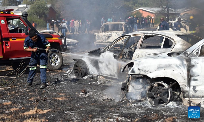 A firefighter tries to put out fire at a site where most of the cars were burnt to ashes in Jwaneng mining town located about 165km west of Gaborone, Botswana, on June 25, 2023. Forty-nine vehicles caught fire in Jwaneng mining town Sunday afternoon in southern Botswana, where the owners were attending the 2023 Toyota Desert Race.(Photo: Xinhua)