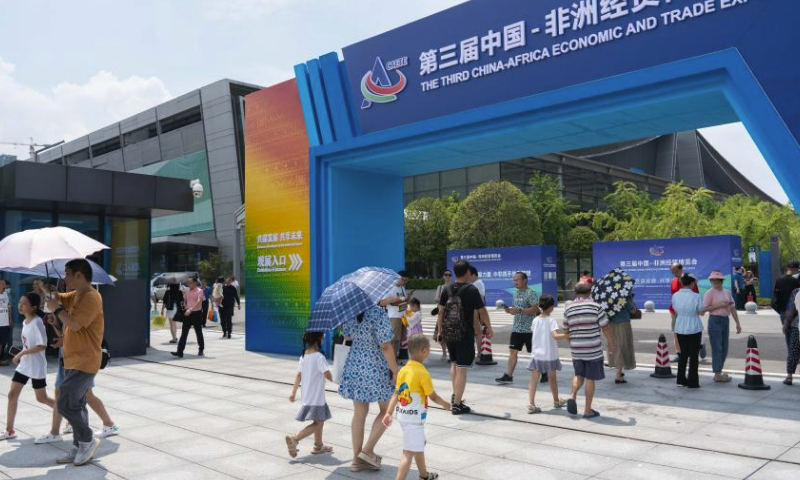 People walk past the entrance of the third China-Africa Economic and Trade Expo in Changsha, central China's Hunan Province, July 1, 2023. The third China-Africa Economic and Trade Expo is held in Changsha from June 29 to July 2. (Xinhua/Zou Yu)