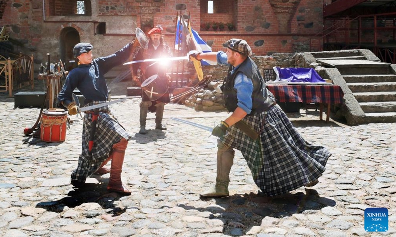Artists reenact a fight at the Mir Castle in Grodno region, Belarus, June 30, 2023. The Mir Castle Complex is a unique monument of Belarusian architecture and was built in the early 16th century. It was listed as a world heritage site by the UNESCO in 2000. (Photo by Henadz Zhinkov/Xinhua)