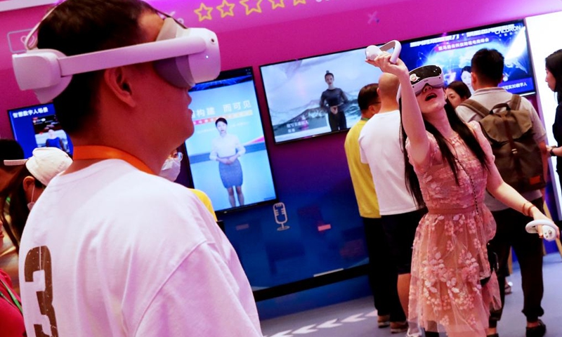Visitors play VR games at the 2023 Amazon Cloud Technology China Summit in Shanghai, east China, June 28, 2023.The 2-day summit concluded here on Wednesday, showcasing advanced technologies including VR, AI and cloud computing. (Photo: Xinhua)