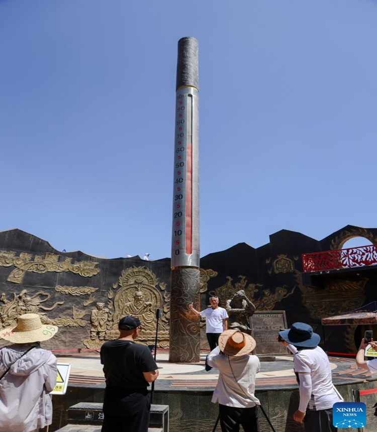 Tourists visit the Flaming Mountain scenic area in Turpan, northwest China's Xinjiang Uygur Autonomous Region, June 27, 2023. The city of Turpan has received 2.53 million tourist visits from June 1 to 28, an increase of nearly 40 percent over the same period in 2022. (Photo: Xinhua)