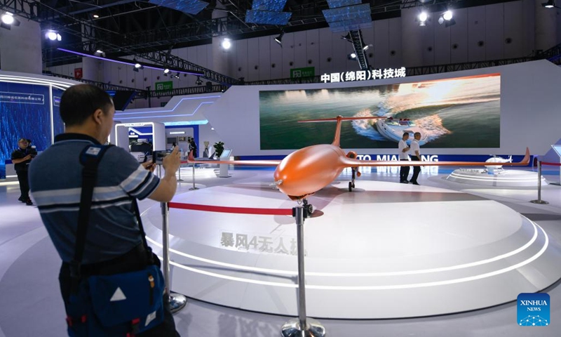 A visitor takes photos of a drone at the Mianyang exhibition area during the 19th Western China International Fair (WCIF) in Chengdu, southwest China's Sichuan Province, June 29, 2023. Kicking off here on Thursday, the five-day fair attracts more than 3,500 enterprises from 56 countries and regions.(Photo: Xinhua)