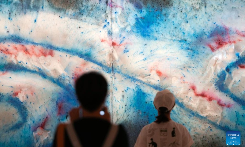 People visit an exhibition of Chinese artist Cai Guoqiang at the National Art Center Tokyo in Tokyo, Japan, June 29, 2023. The exhibition, titled Ramble in the Cosmos-From Primeval Fireball Onward, opened here Thursday and will last until Aug. 21.(Photo: Xinhua)