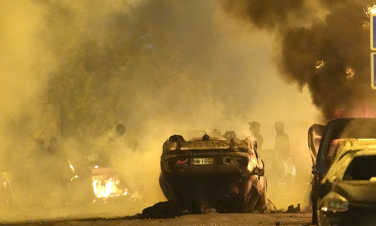 A car burns during clashes between local youths and police in Nanterre, France, on June 29, 2023. Photo: VCG