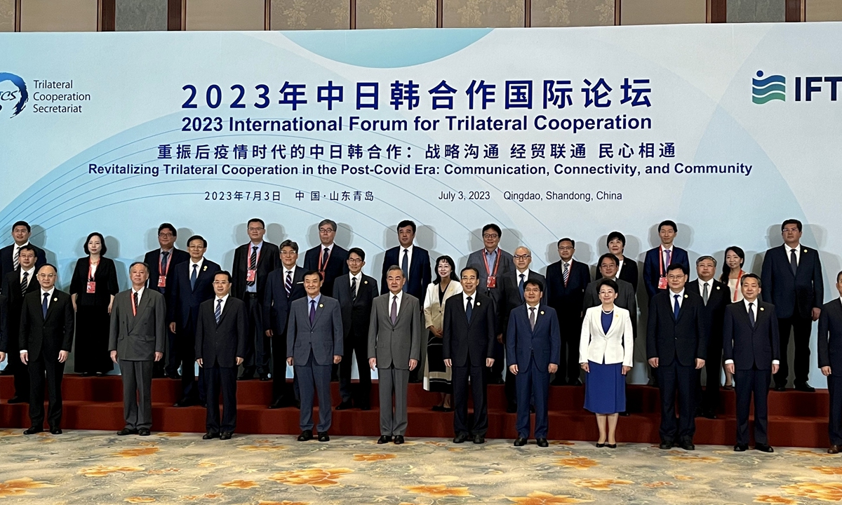 Wang Yi (5th from left, front row), a member of the Political Bureau of the Communist Party of China (CPC) Central Committee and director of the Office of the Foreign Affairs Commission of the CPC Central Committee,and other participants of a forum meeting on cooperation among China, Japan and South Korea pose for a photo in Qingdao, China, on July 3, 2023.Photo: Xu Keyue/GT